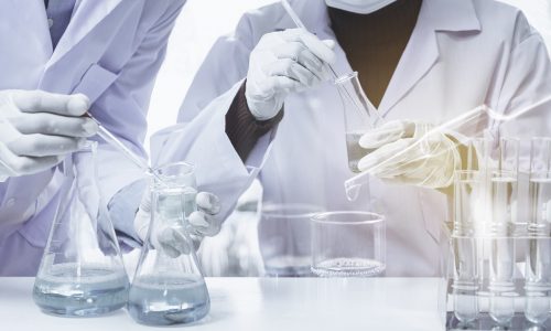 Researcher with glass laboratory chemical test tubes with liquid for analytical , medical, pharmaceutical and scientific research concept.