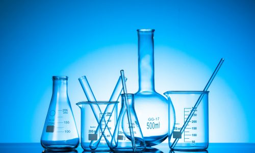 A variety of glass flasks and lab equipment on a blue background